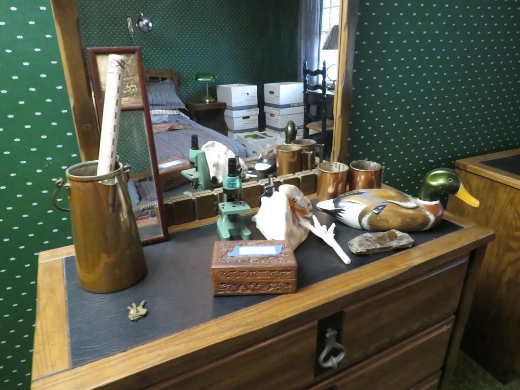 Wooden dresser with mirror; items on top include a duck decoy, jars, and a box.
