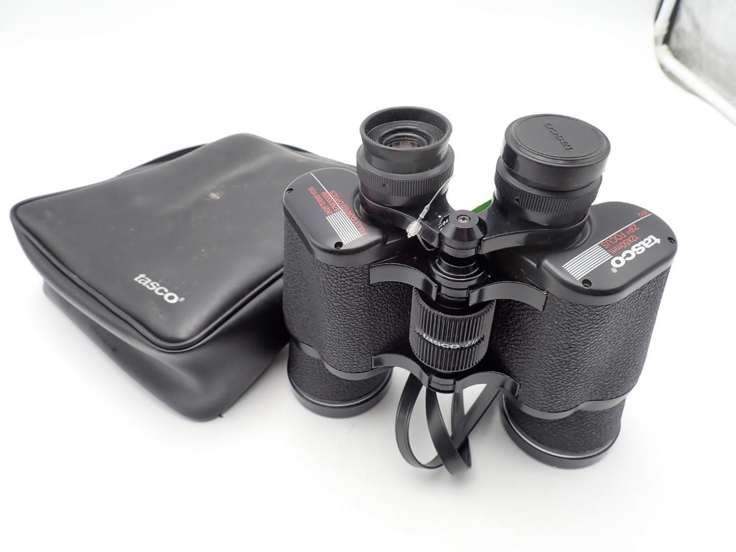 Black binoculars with a carrying case on a white background.