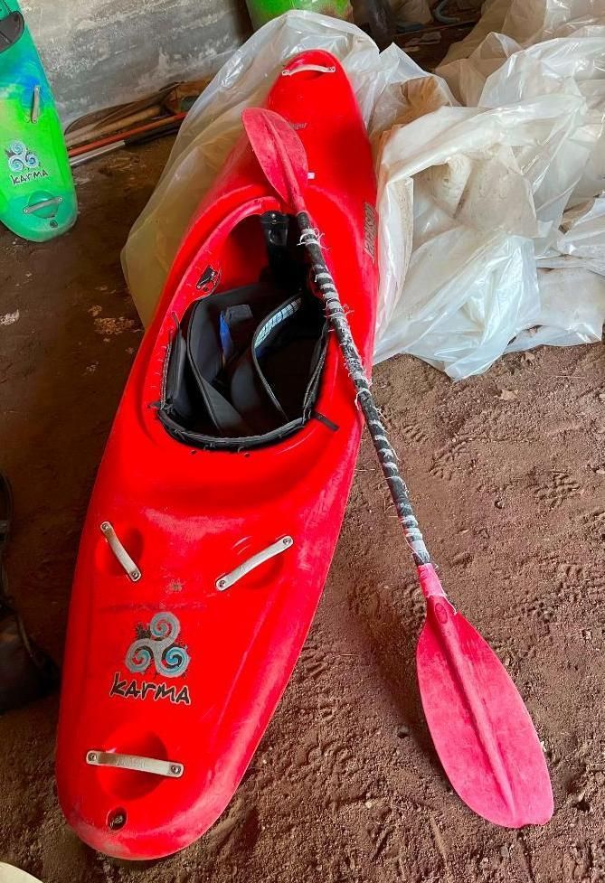 Red kayak with a paddle.