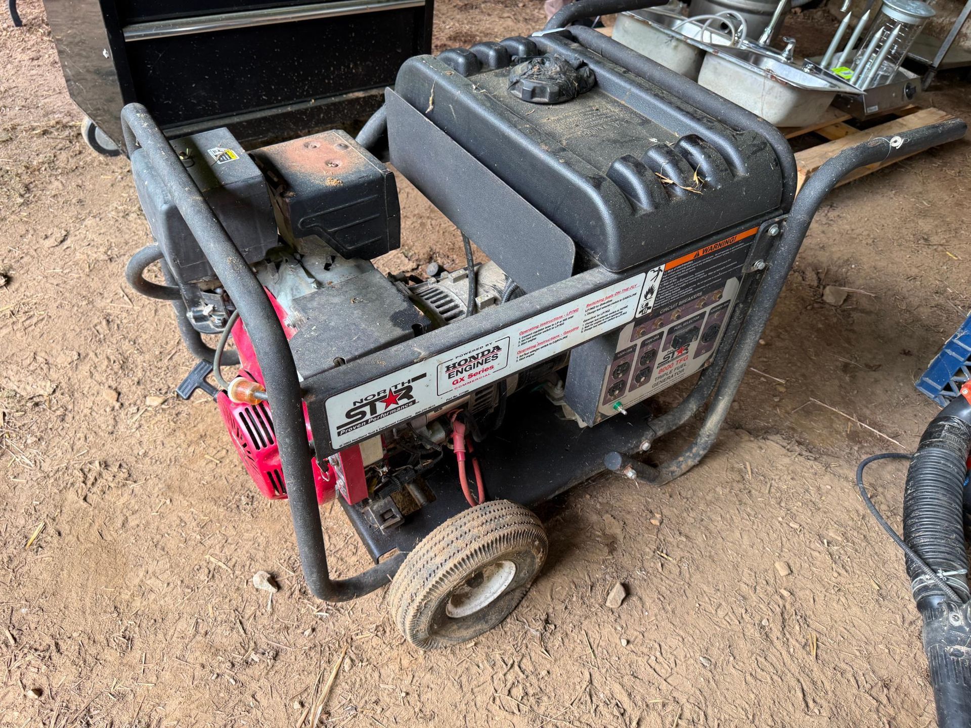 Generator with red engine and black frame and housing.