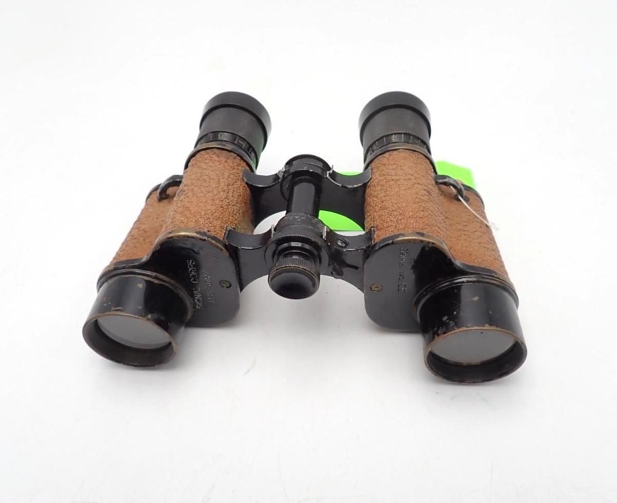 Compact brown-and-black binoculars on a white background