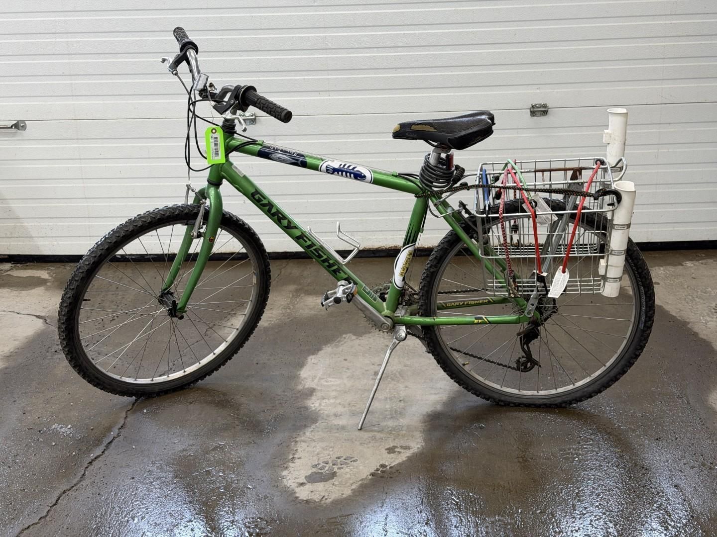 Green bicycle with custom rear rack, parked.