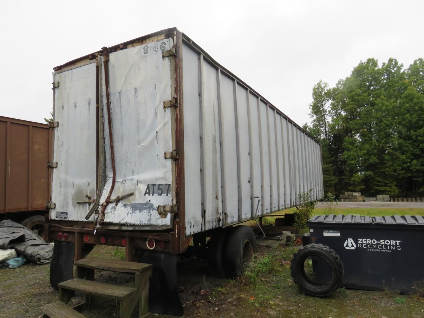 A gray semi-trailer parked outdoors.