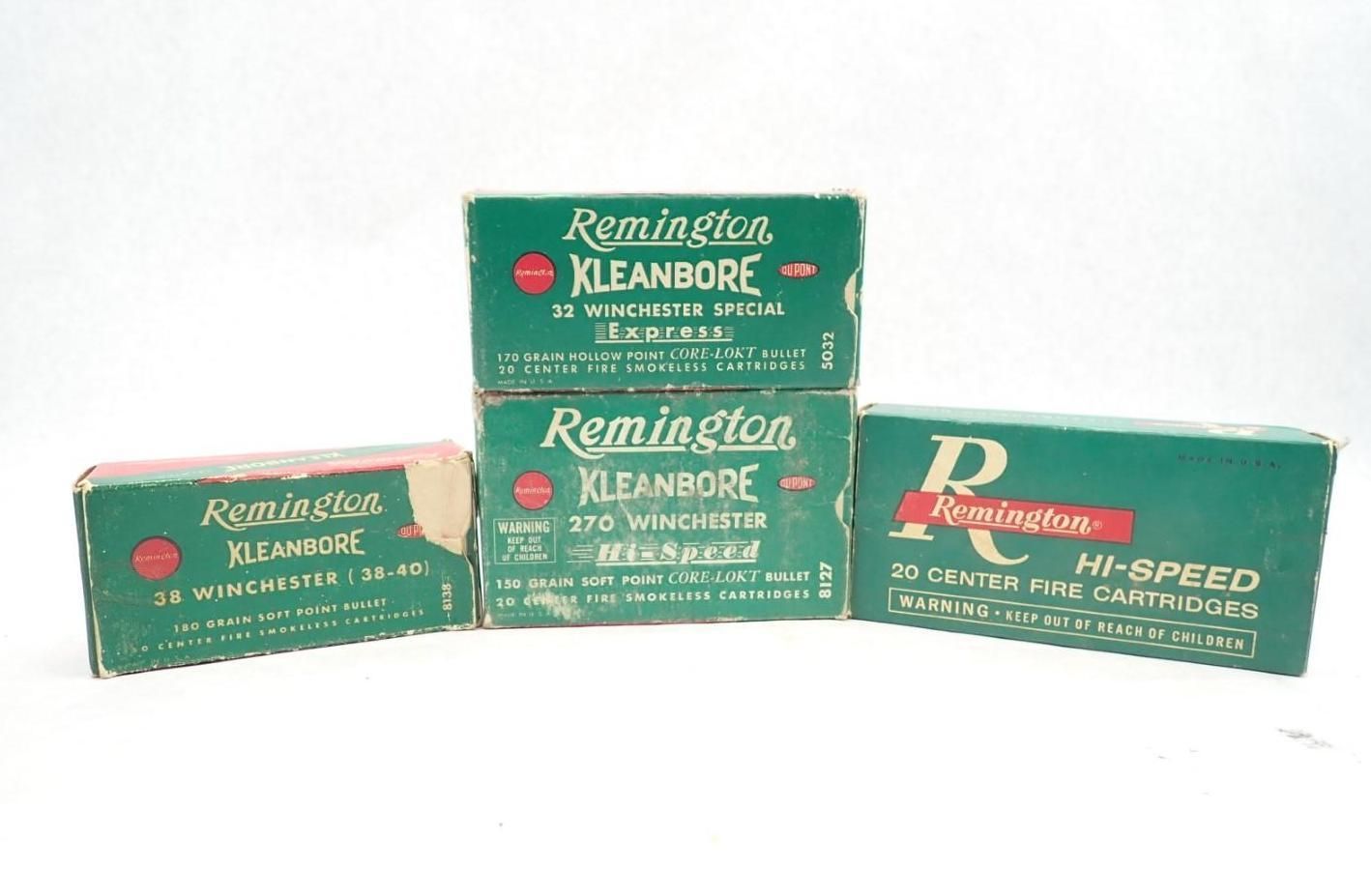 Four vintage Remington ammunition boxes in green and red against a white background.