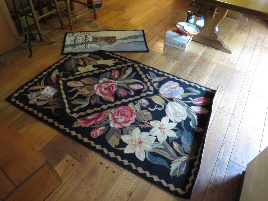 Two floral rugs on wooden floor with a small rectangular rug.