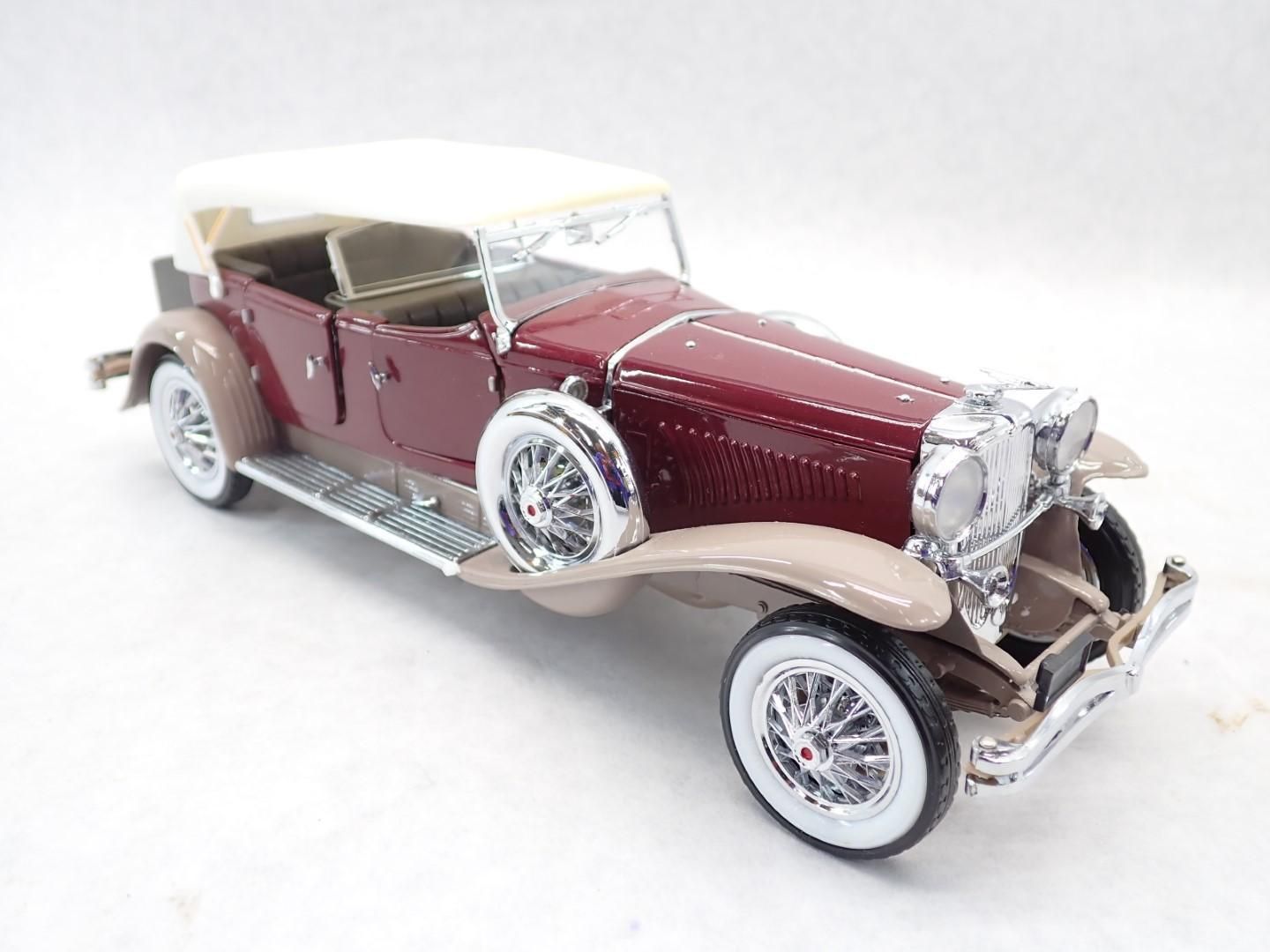 Burgundy and tan classic convertible car model with white top and whitewall tires.