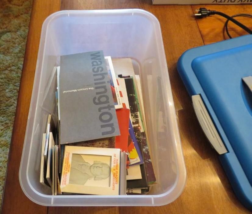 Clear plastic bin filled with papers and slides.