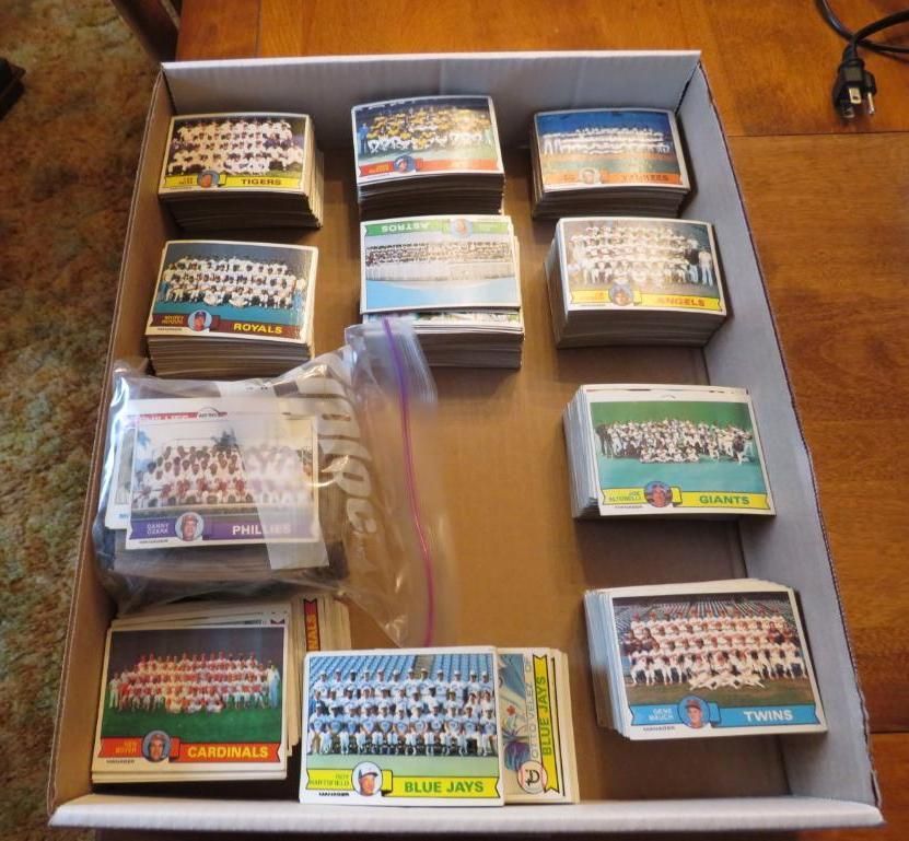 Cardboard box filled with stacks of team photo trading cards.