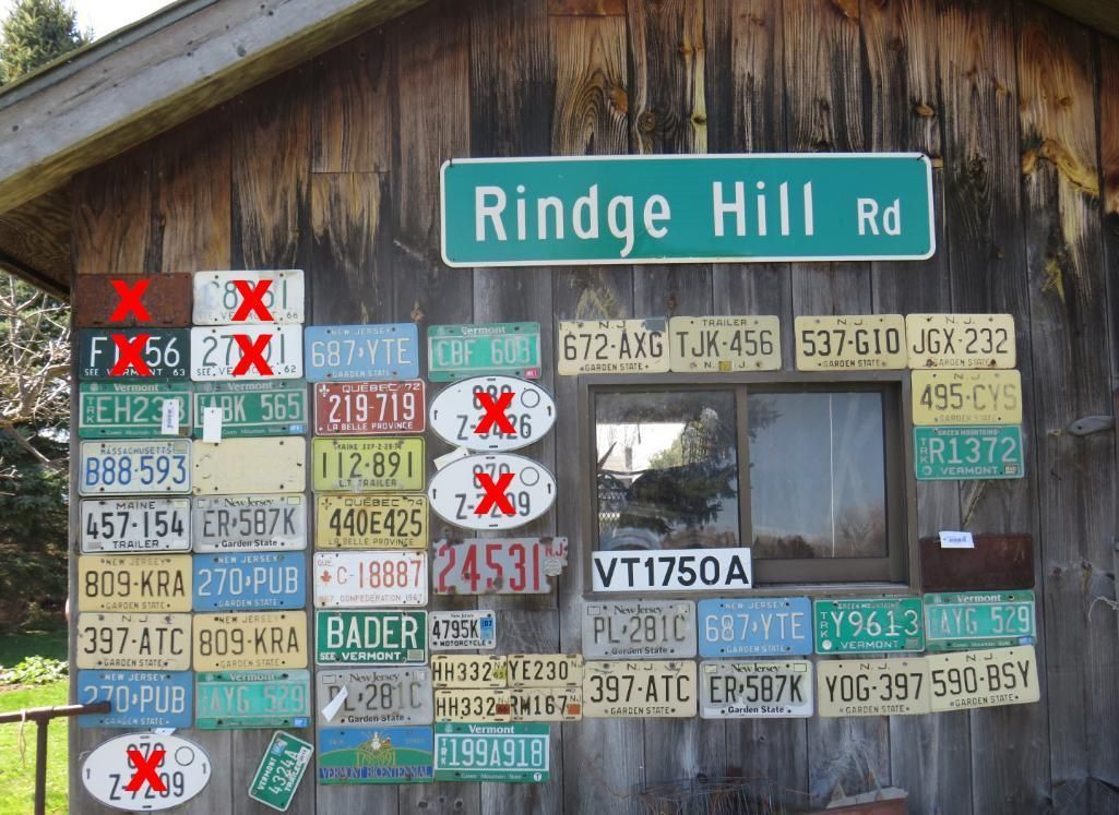 A wooden building with license plates and a