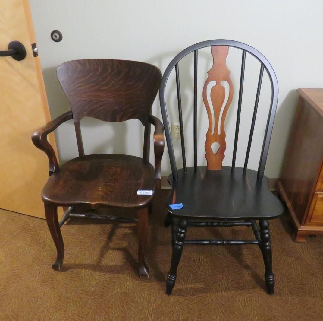 Two wooden chairs of different styles, one dark, one lighter. They are indoors on a brown carpet.