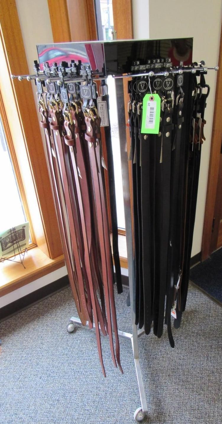 Display rack with brown and black belts hanging.