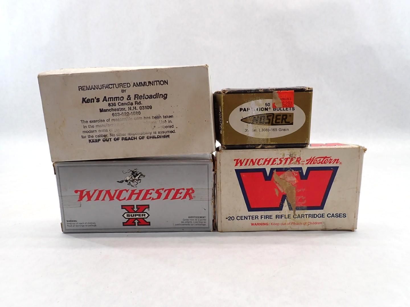 Four boxes of ammunition, with labels from various brands, on a white surface.
