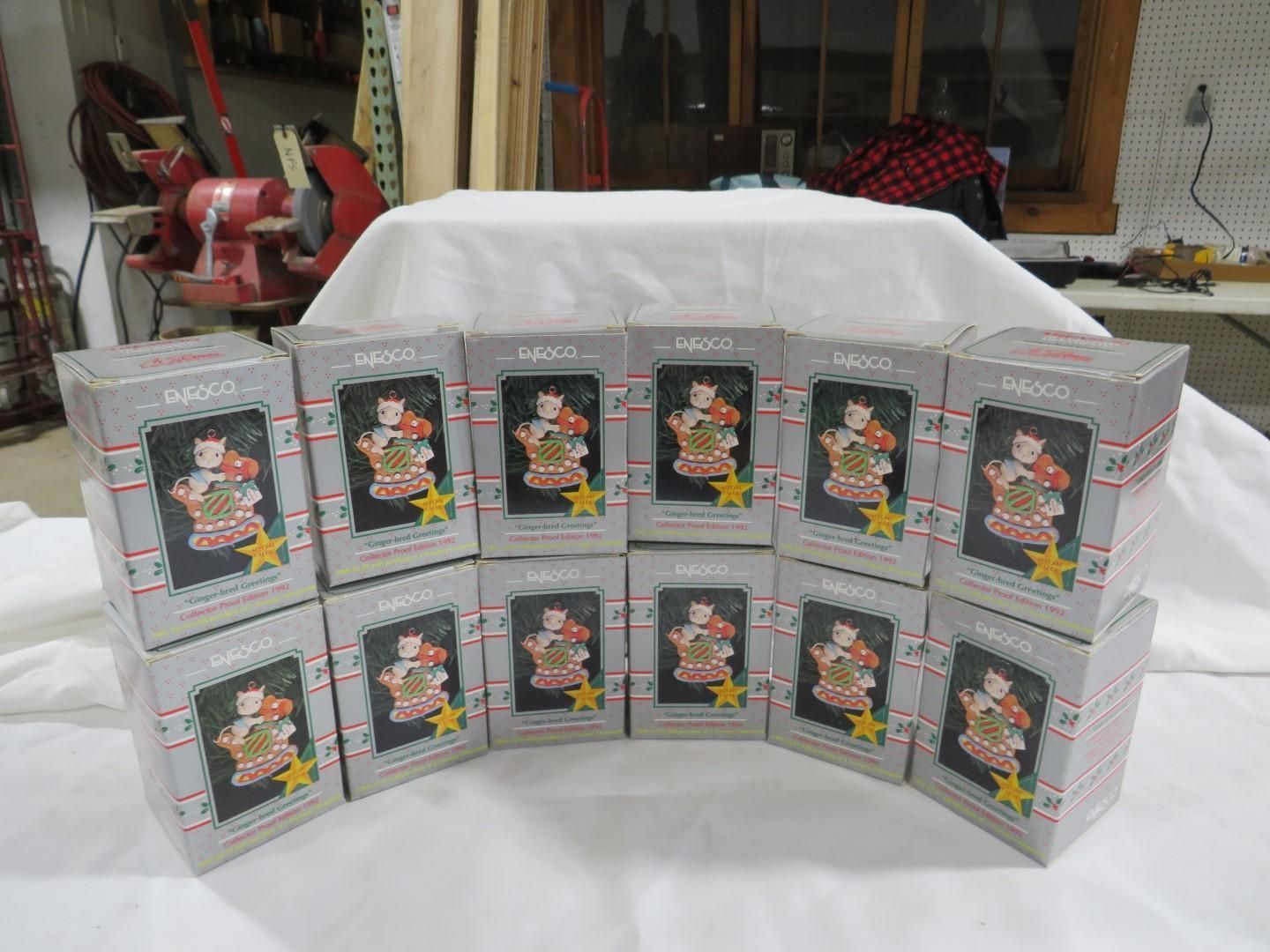 Twelve boxed ornaments arranged on a white surface, each featuring a figure and a star.