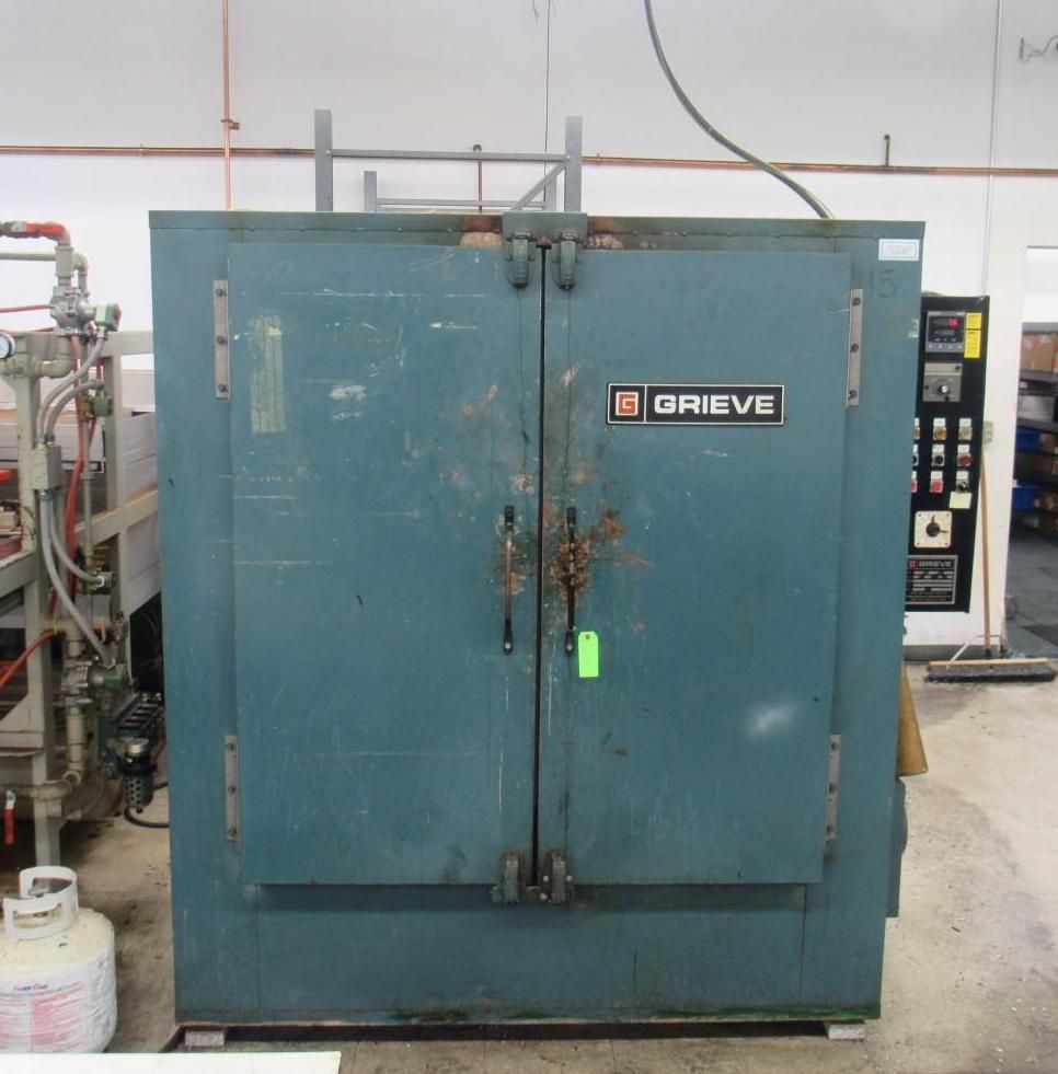 Large, teal Grieve industrial oven with double doors, control panel, and gas tank.
