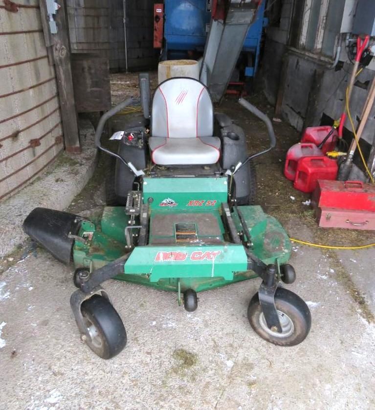 Green Bobcat zero-turn lawn mower parked indoors.