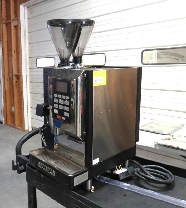 Stainless steel espresso machine with dual hopper, buttons, and a digital display.