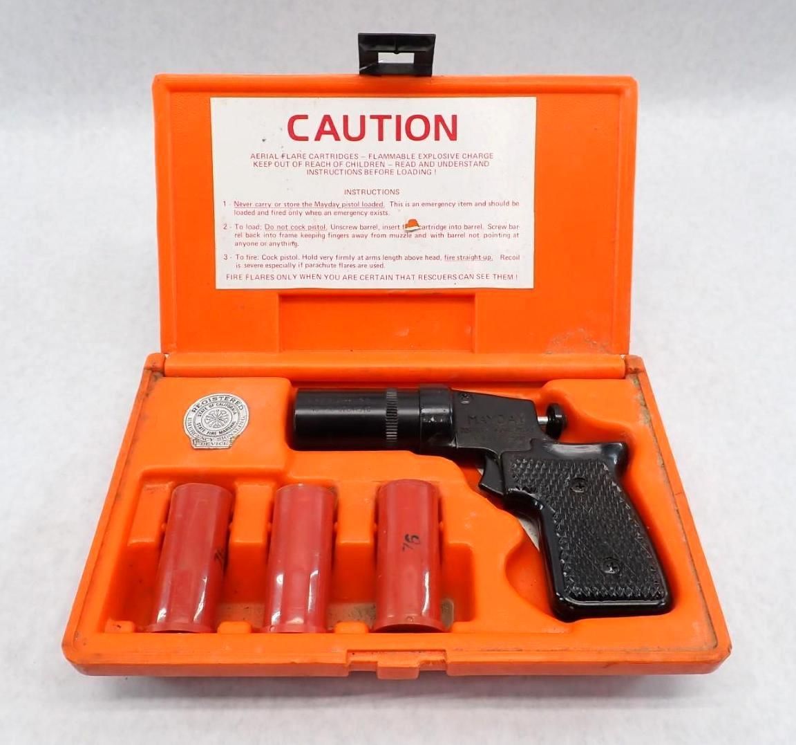 Orange case containing a black flare gun, three red flares, and a silver disc with a label.