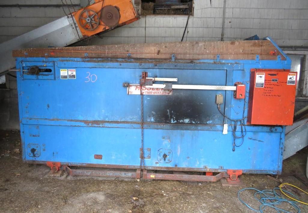 Blue industrial incinerator with orange control box and metal components.