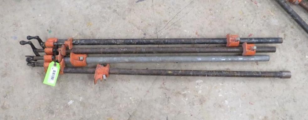 Several pipe clamps on a concrete surface.