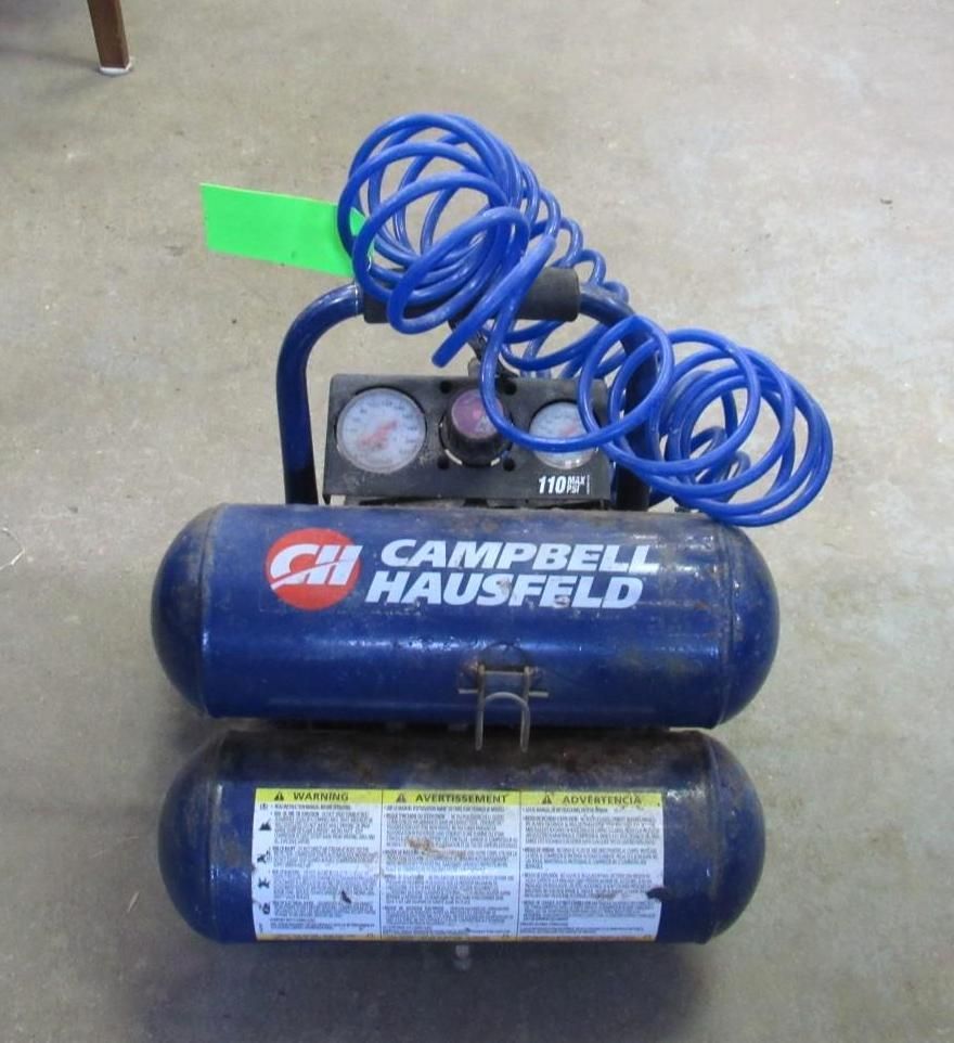 Blue Campbell Hausfeld air compressor with gauges and coiled hose.
