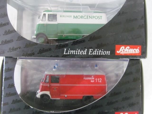 Two Schuco model vans in boxes: green
