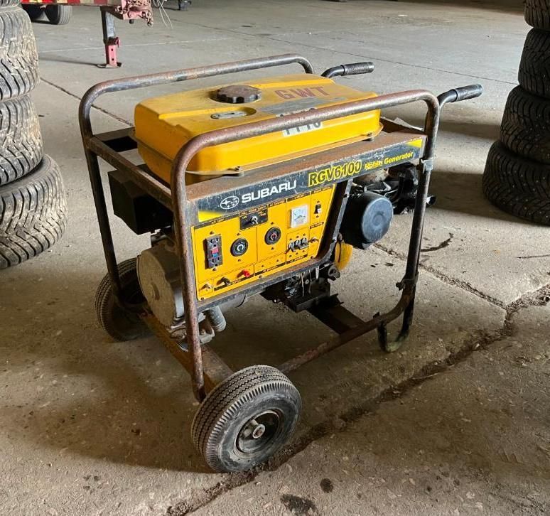 Yellow Subaru generator with wheels on a concrete surface.