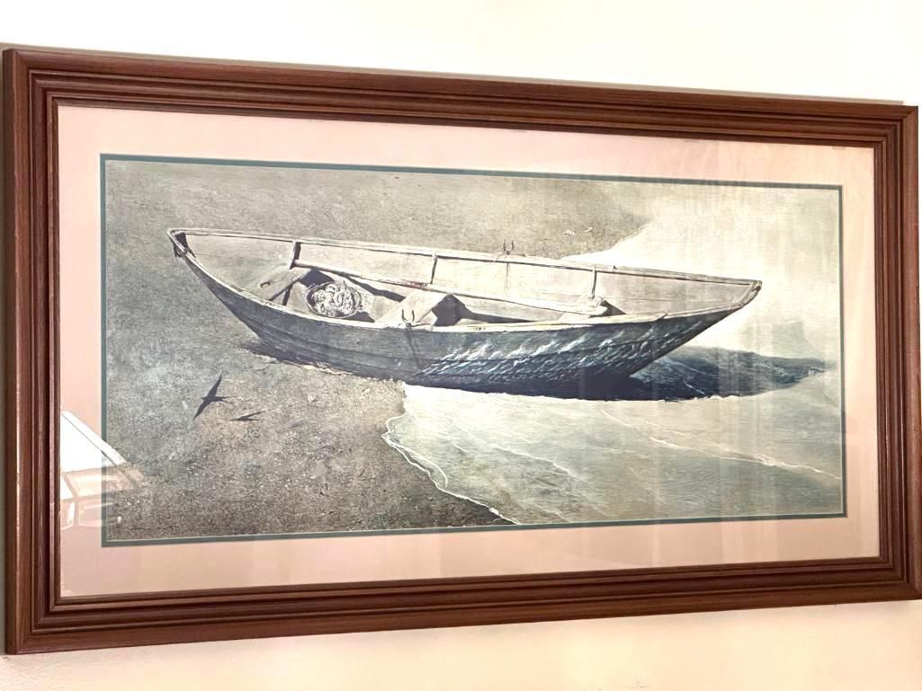 Framed print of a beached boat on a sandy shore with muted blue and gray tones.