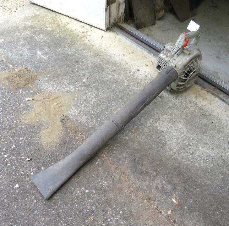 Gas-powered leaf blower on a concrete surface.