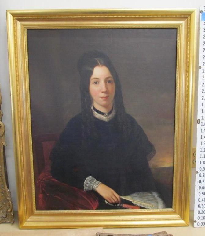 Portrait painting in ornate gold frame, woman in dark dress, holding a fan.