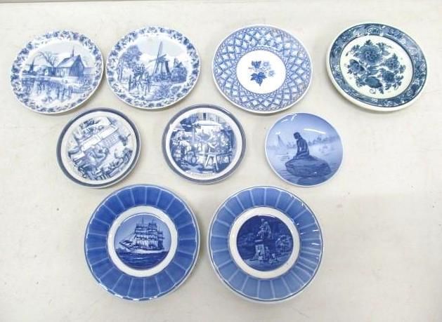 Collection of blue and white decorative plates with various scenes.