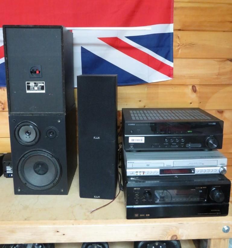 Audio equipment on a wooden shelf: large speaker, small speaker, receiver, DVD player, and an amplifier.