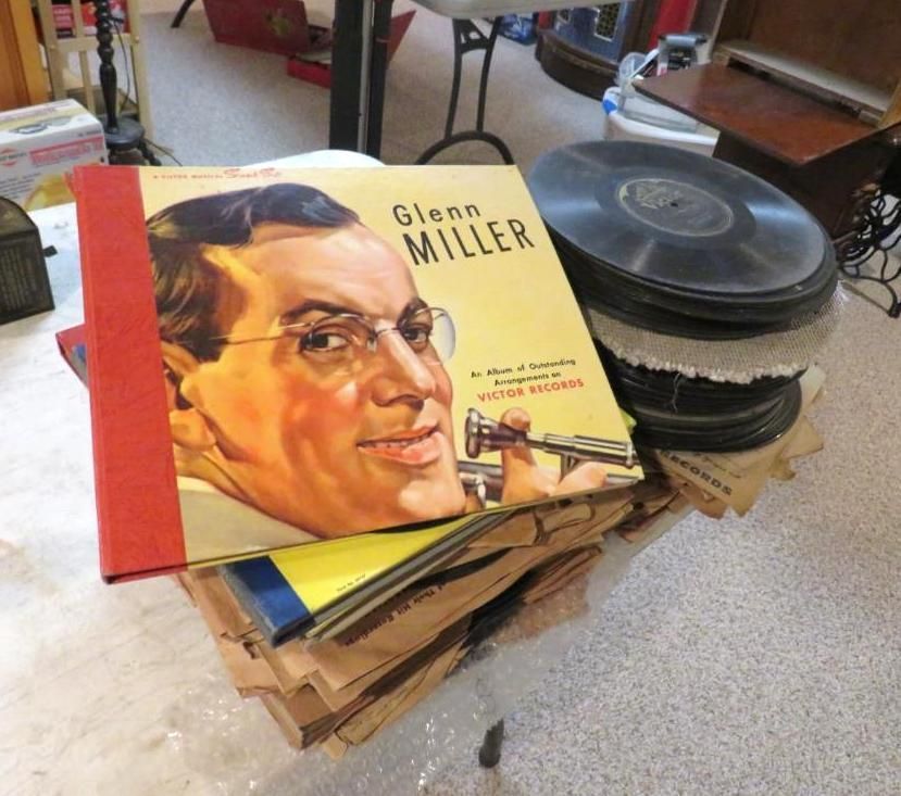 Stack of Glenn Miller records with album cover art featuring a man in glasses.