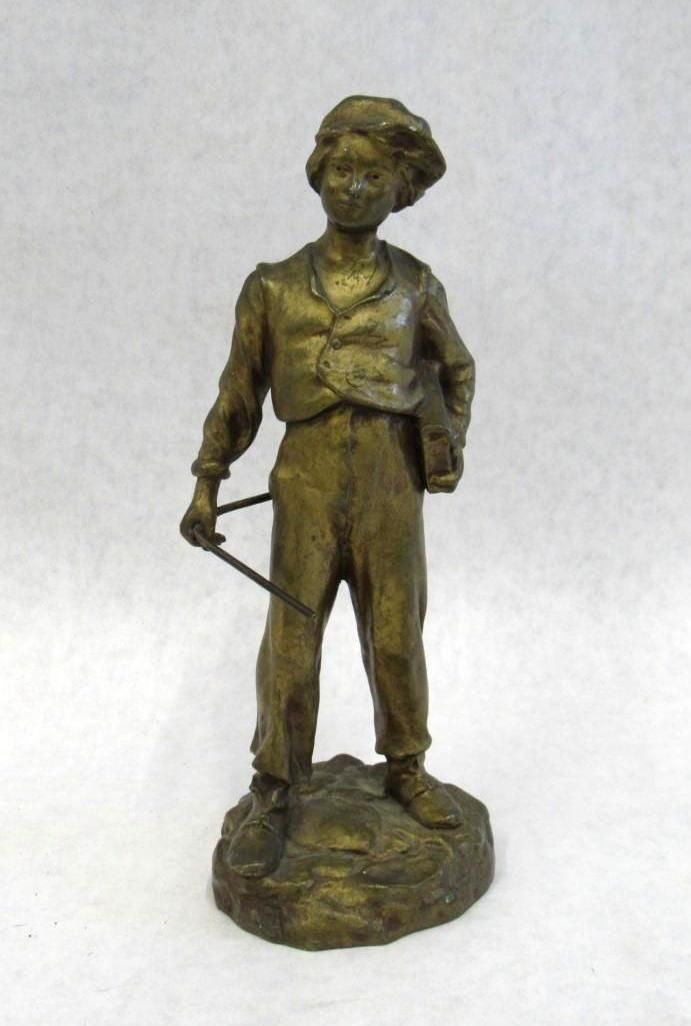 Bronze statue of a person holding what appears to be a musical instrument.