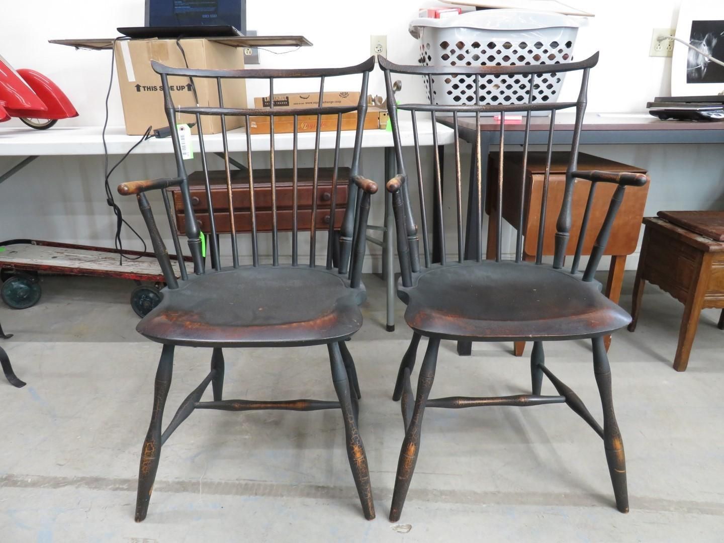 Two dark wooden spindle-back chairs with dark seat cushions.