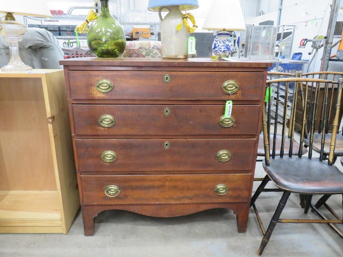 Brown antique dresser with four drawers and brass hardware.