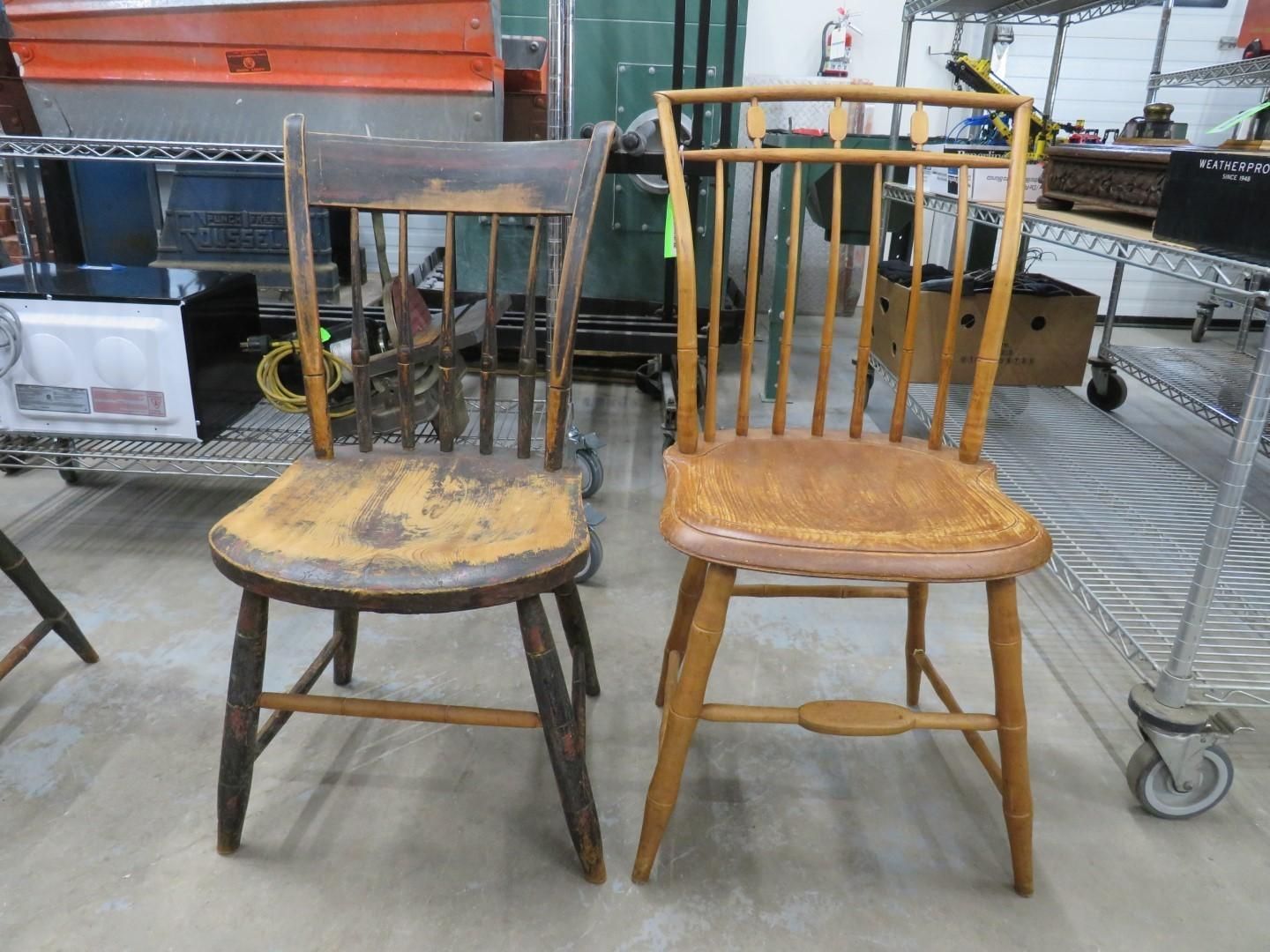 Two wooden chairs, one dark, one light, side by side in a room.
