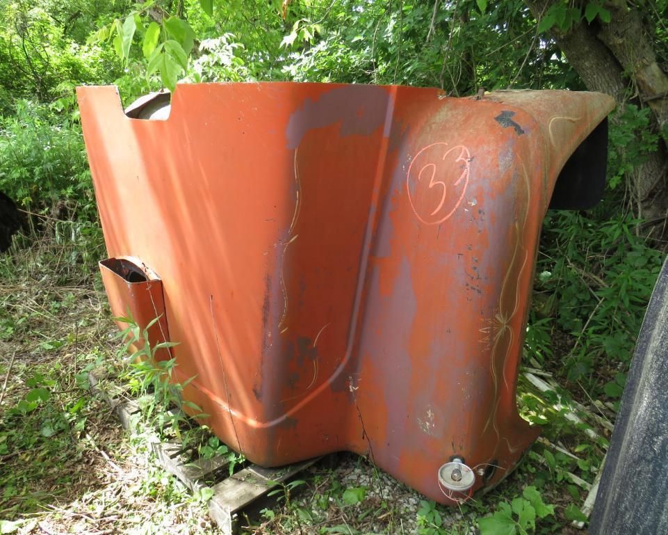 Orange vehicle hood with number 33 scrawled on it.