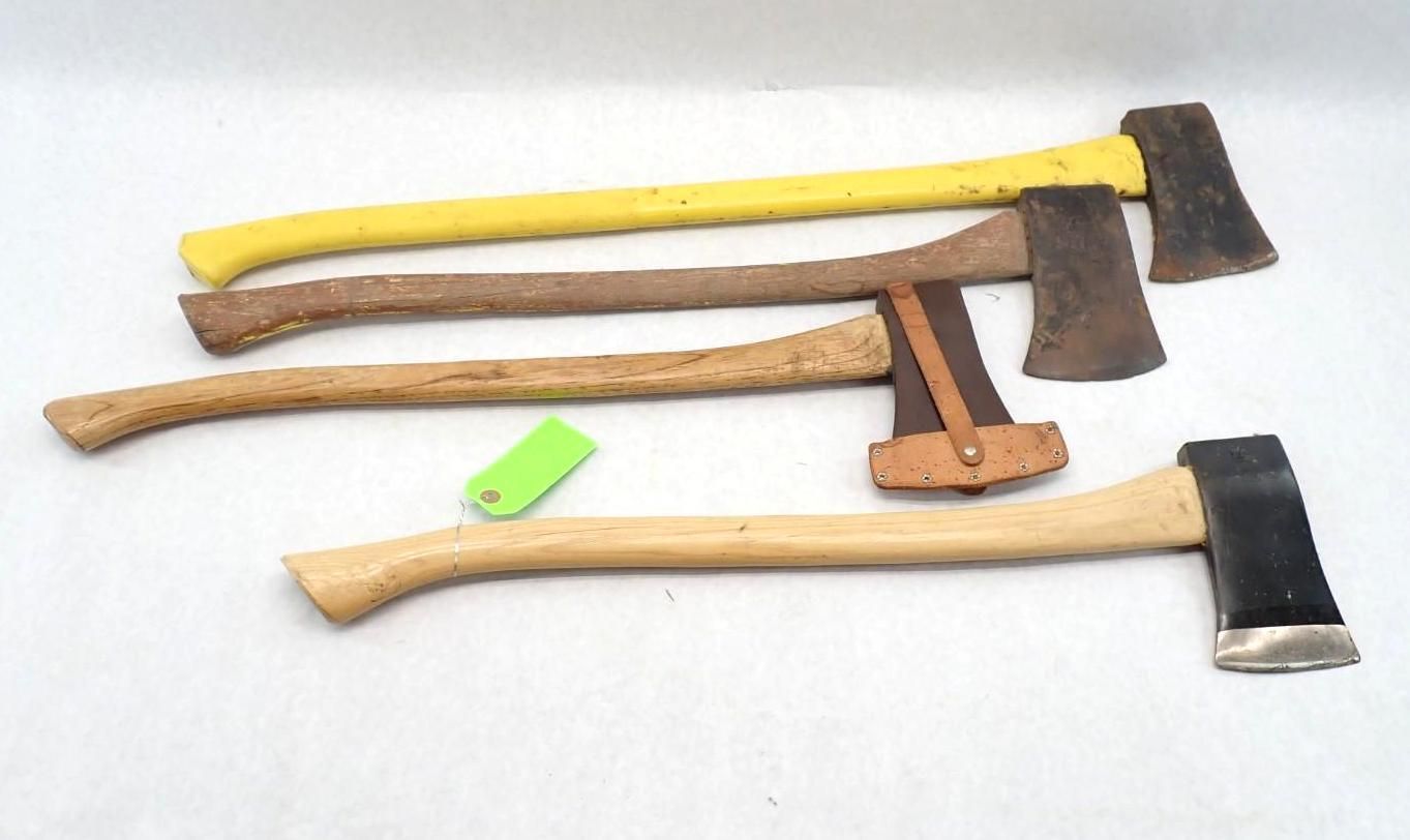 Four hatchets with wooden handles, three wood and one yellow, arranged on a white surface.
