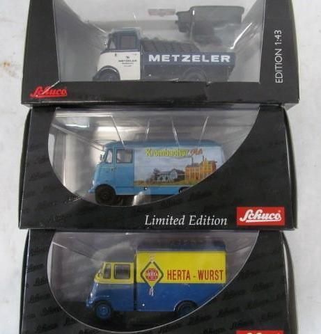 Three model trucks in boxes: Metzeler, Gutsmann, and Herta Wurst, all in boxes.