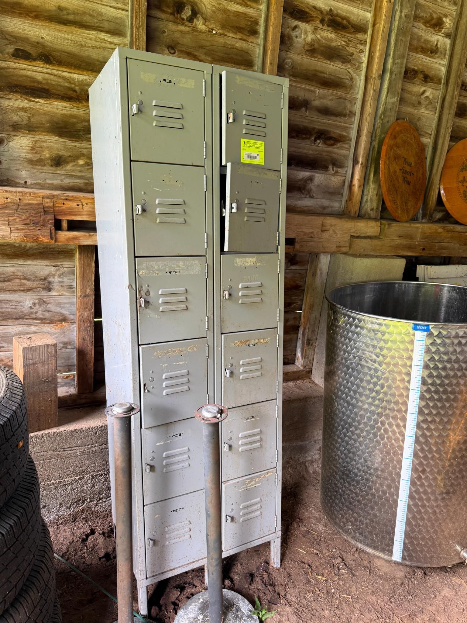 Two gray metal lockers inside a wooden structure.