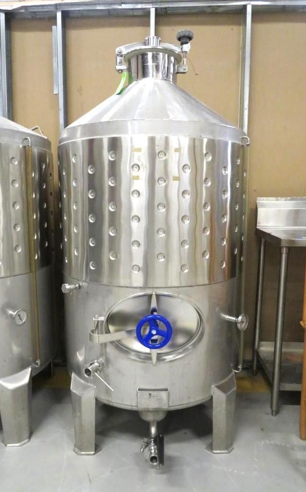 Stainless steel fermentation tank with oval door and blue valve.