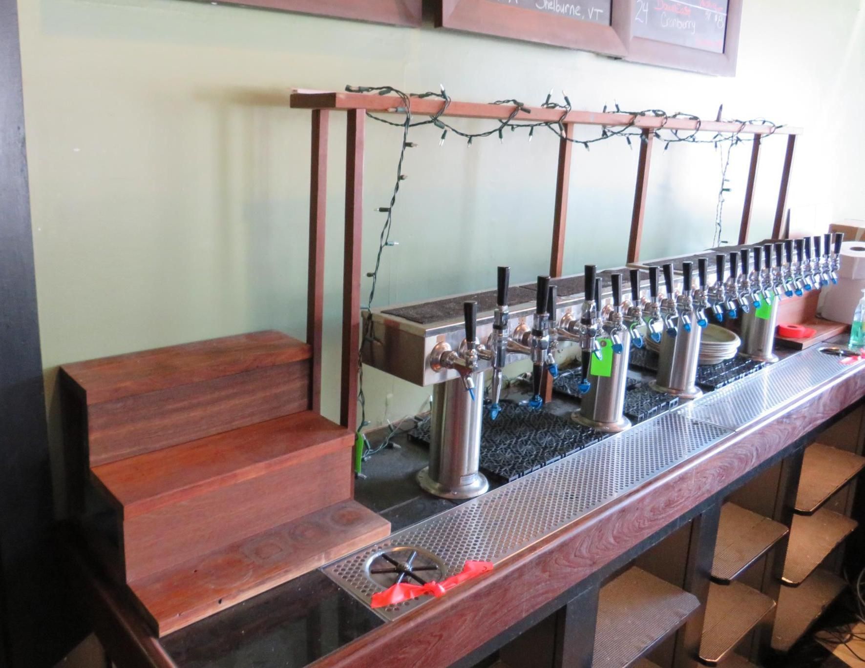 Bar with numerous beer taps, wooden accents.