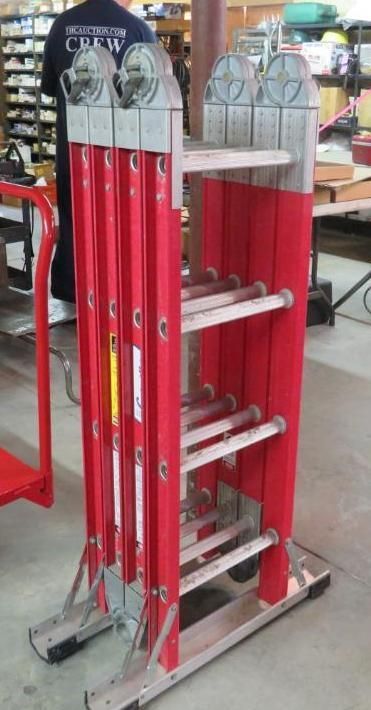 Red and silver multi-position ladder in a warehouse setting.