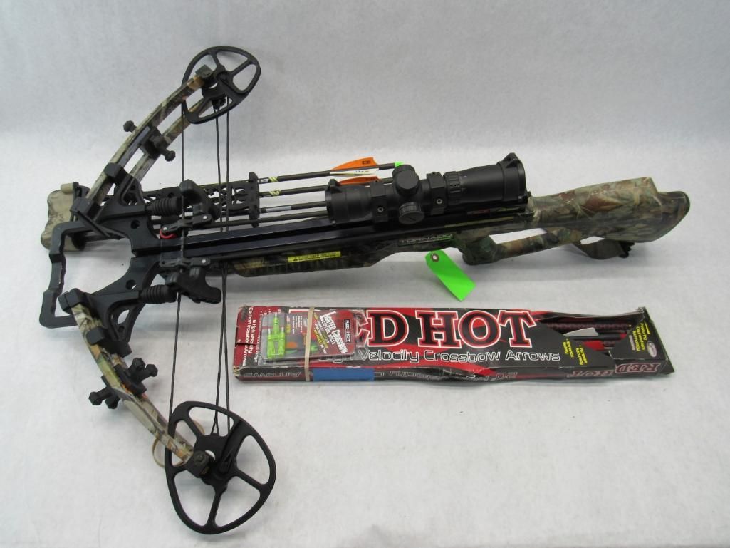 Crossbow with mounted scope and arrows, camo limbs, black frame, and a package of