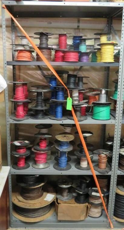 Shelving unit filled with spools of colorful electrical wire.