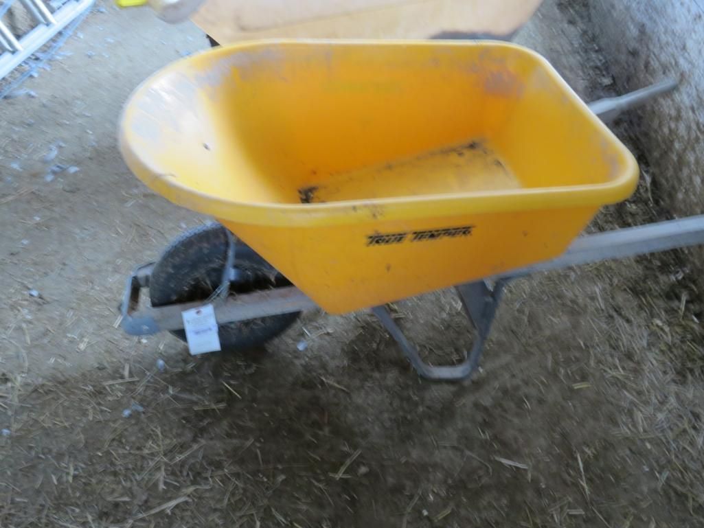 Yellow wheelbarrow on a floor.