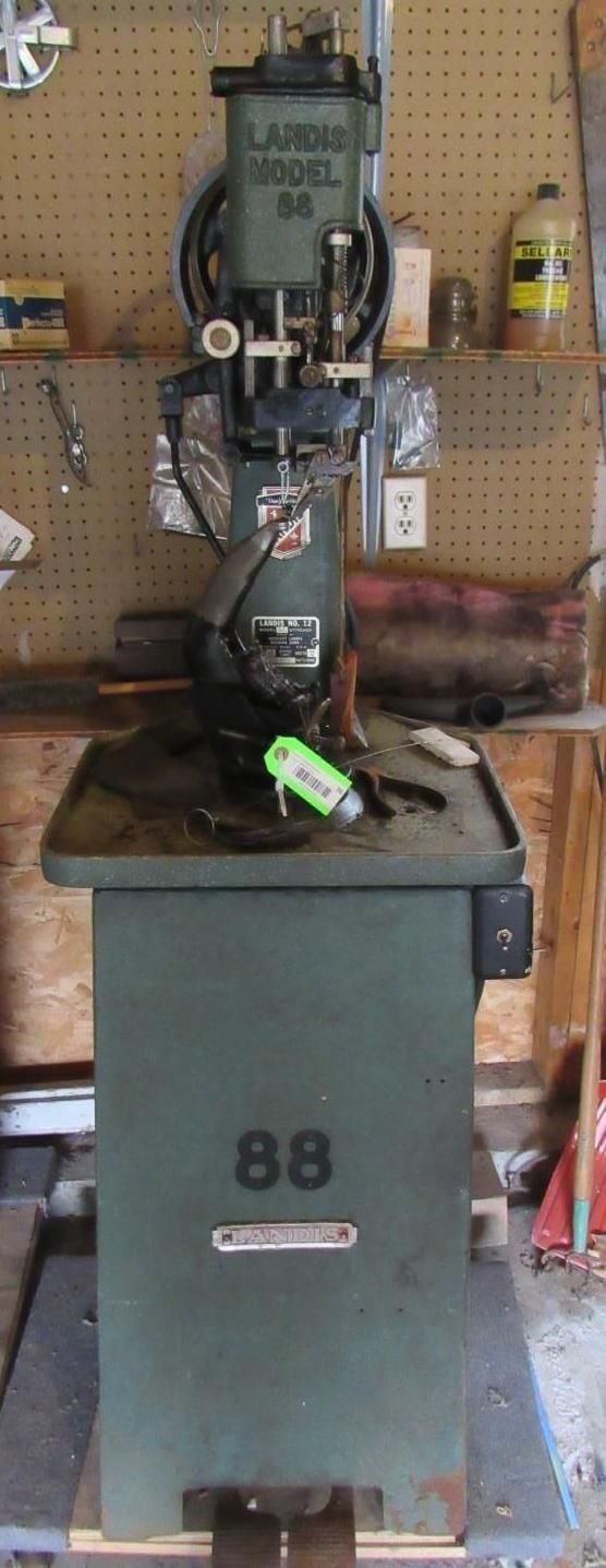 A green, industrial, vertical machine labeled