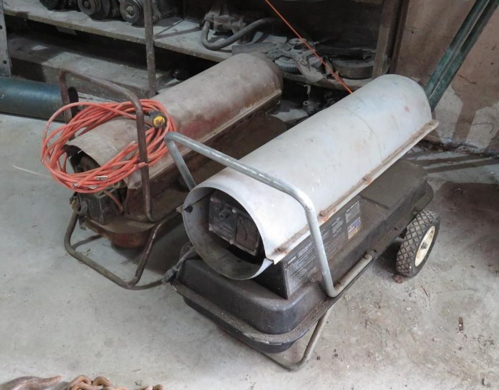 Two portable space heaters in a workshop; one has an orange extension cord.