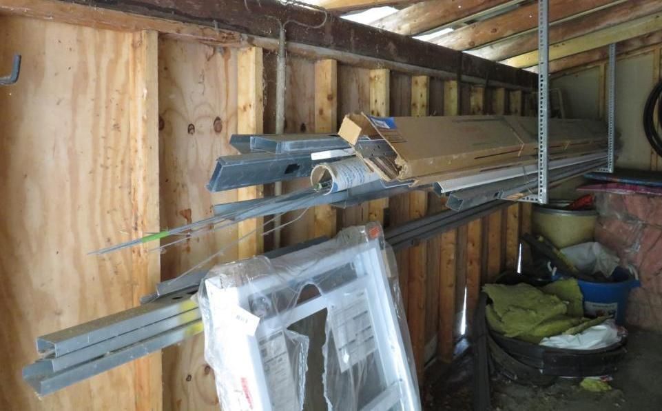 Wood and metal shelving holding various building materials.
