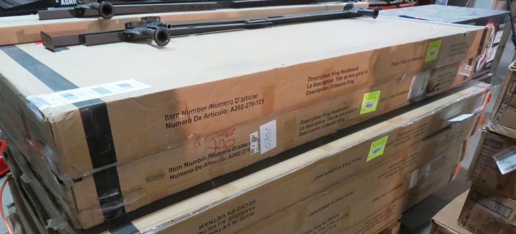Cardboard boxes stacked, with metal bars on top.